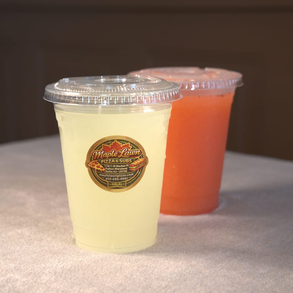 Two lidded beverages, one pale yellow and one red, sit on a table with a Maple Lawn Pizza & Subs label.